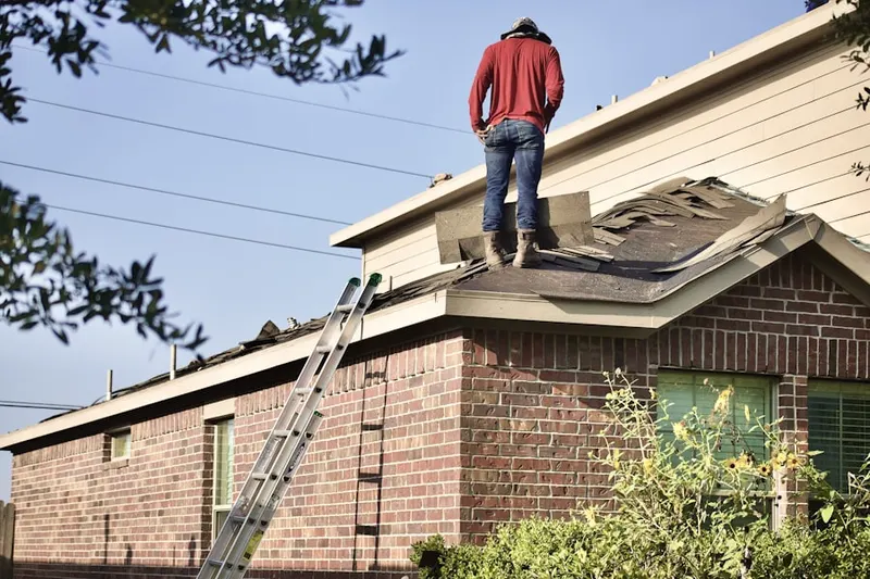 Professional roofer working on a residential roof in Blue Gulf Beach
